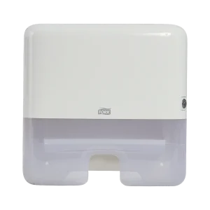 Dispensador Tork de toallas interdobladas mini, de plástico color blanco y gris translúcido. Con diseño compacto y funcional para espacios reducidos, asegura dispensación individual, higiene y comodidad.